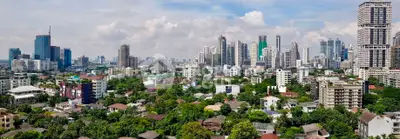 Stunning panoramic cityscape view showcasing urban skyline and lush greenery, perfect for real estate investment.