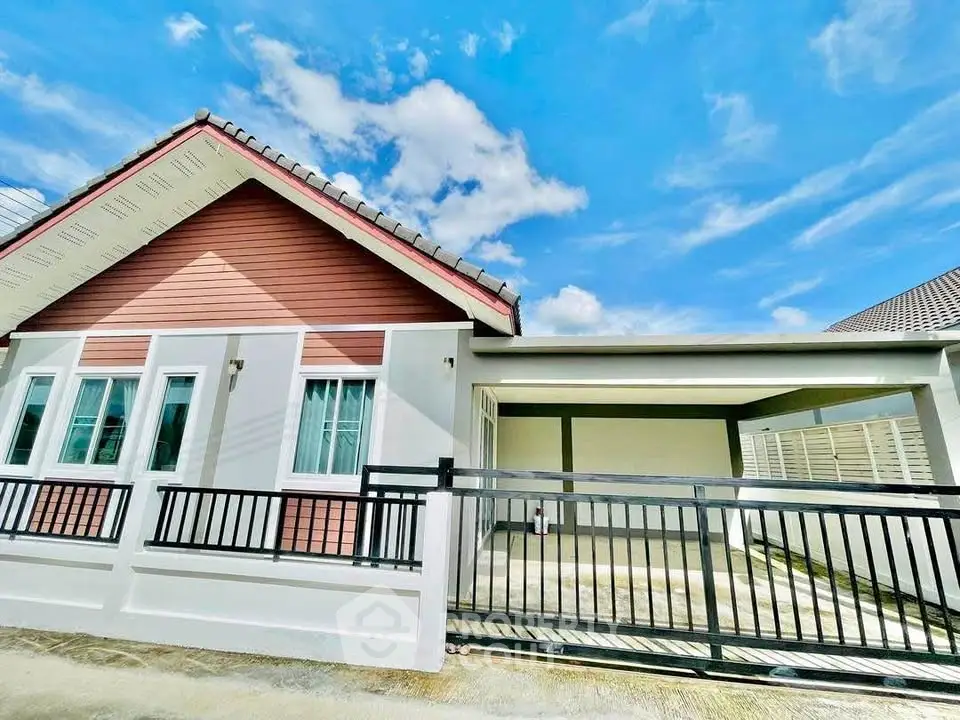 Charming single-story home with modern design and spacious driveway under a clear blue sky.