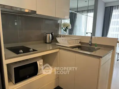 Modern kitchen with sleek white cabinets and built-in appliances