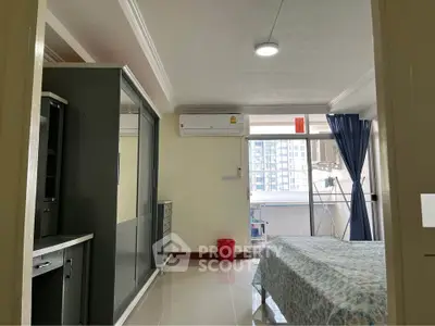 Spacious bedroom with balcony view in modern apartment