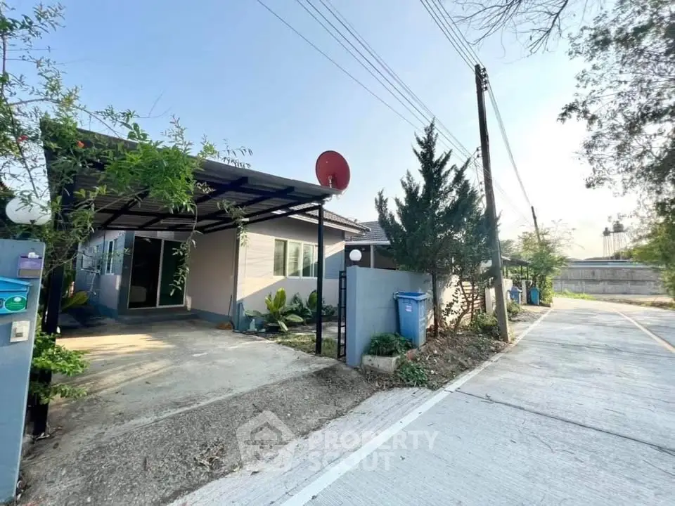 Charming single-story home with driveway and lush greenery in a serene neighborhood.