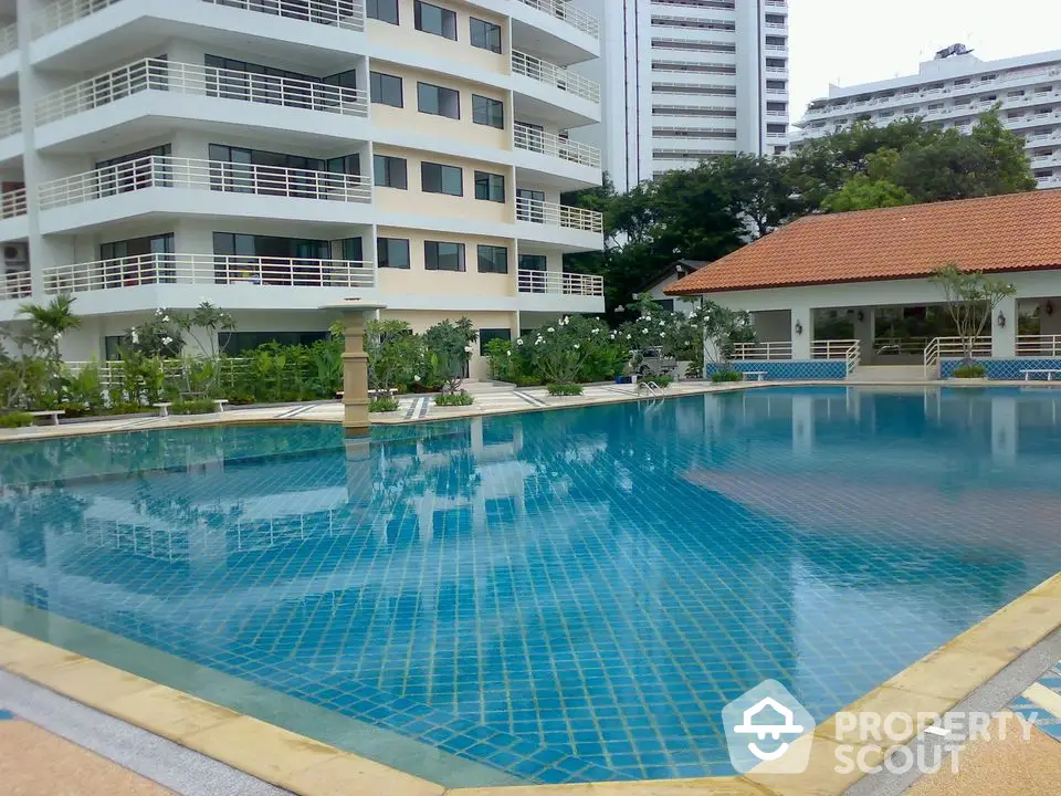 Luxurious condominium with stunning pool and lush garden view