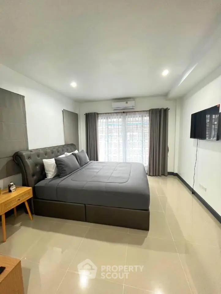 Spacious modern bedroom with elegant decor and natural light