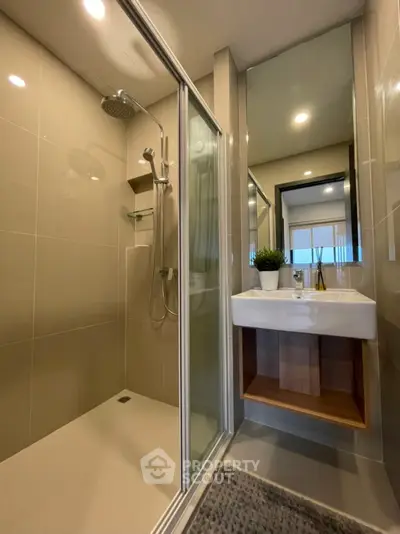 Modern bathroom with glass shower and sleek sink design