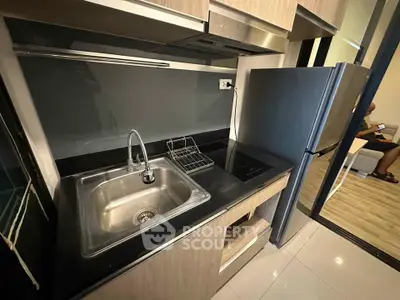 Modern kitchen with sleek black countertop and stainless steel appliances
