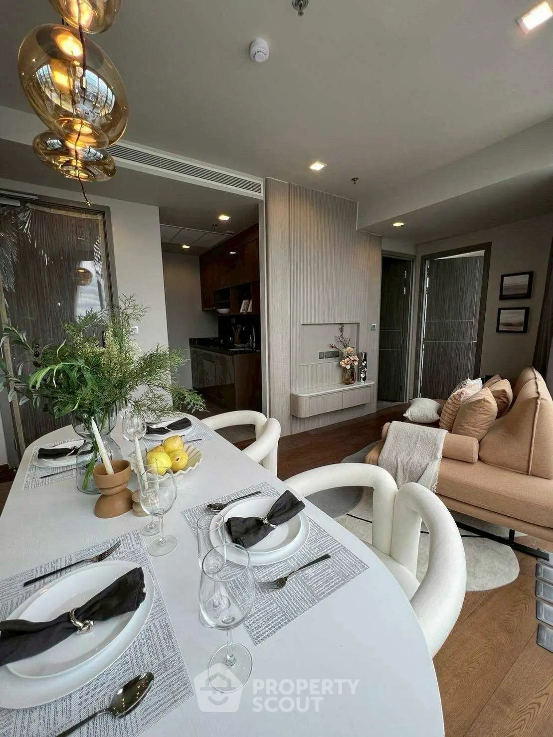 Modern living room with elegant dining setup and cozy seating area