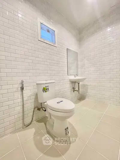 Modern bathroom with white subway tiles and sleek fixtures