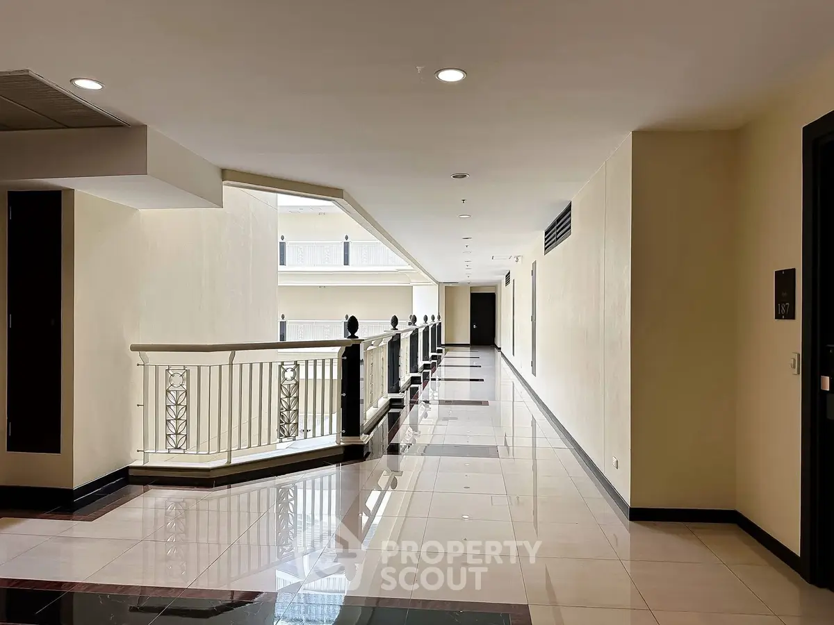 Spacious and elegant building hallway with polished floors and modern design.