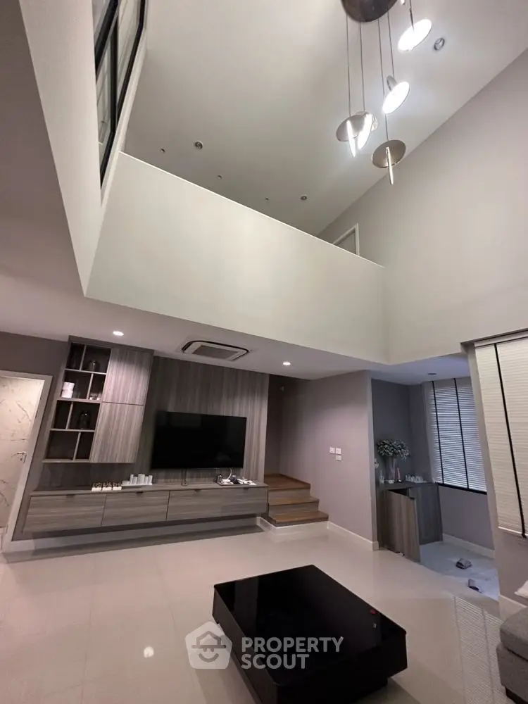 Spacious modern living room with high ceiling and elegant decor