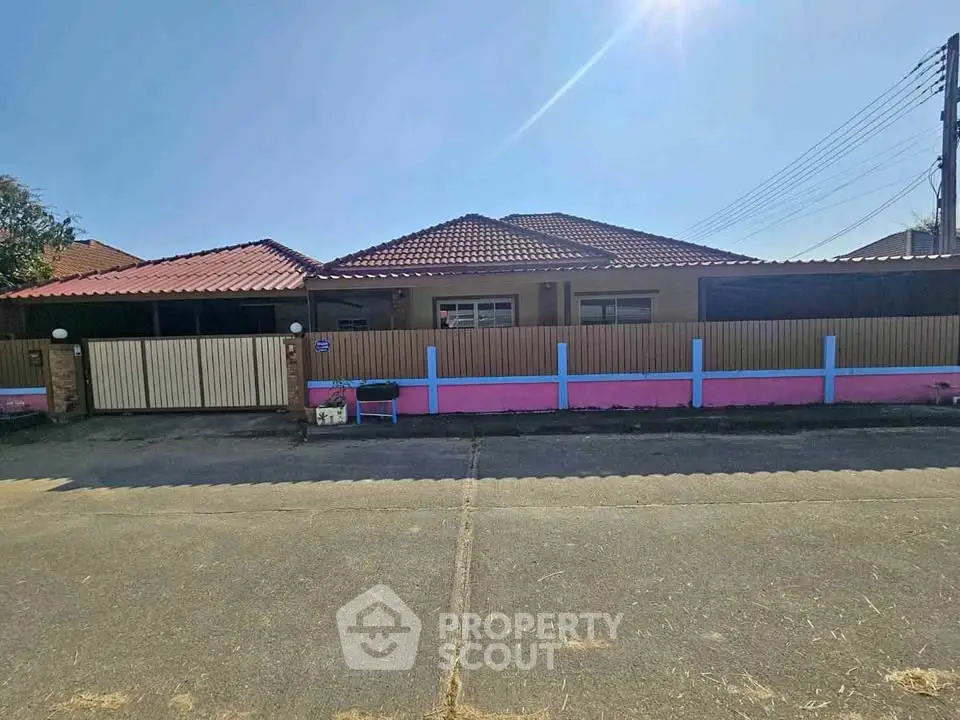 Charming single-story home with tiled roof and fenced yard in a quiet neighborhood.