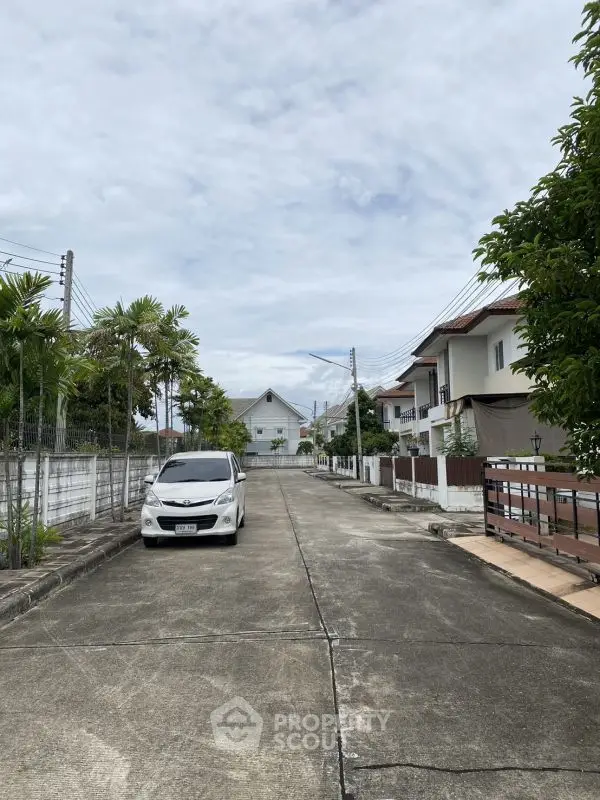 Charming suburban street view with modern houses and lush greenery, perfect for family living.