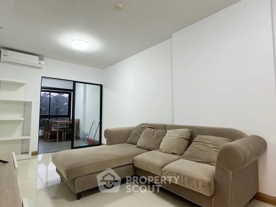 Spacious living room with cozy beige sofa and modern decor