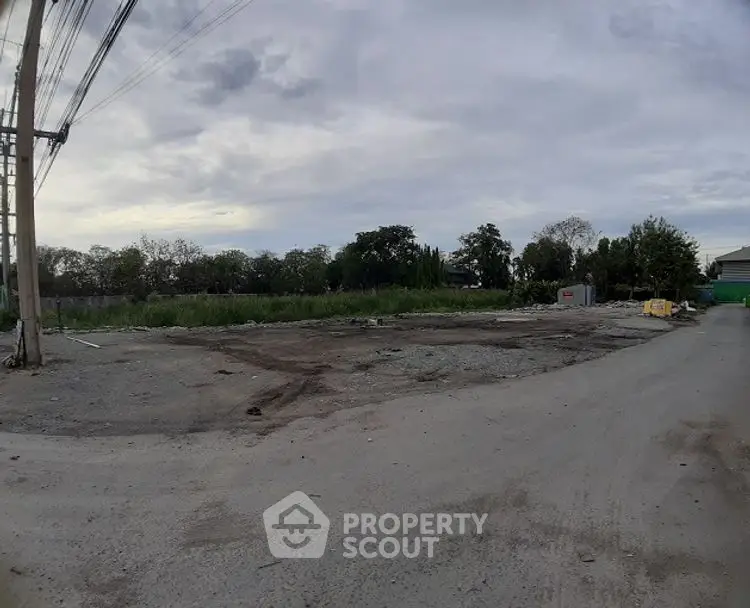 Vacant land plot ideal for development with road access and greenery views.