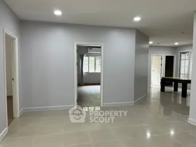 Spacious modern interior with sleek tile flooring and ample natural light, perfect for versatile living arrangements.