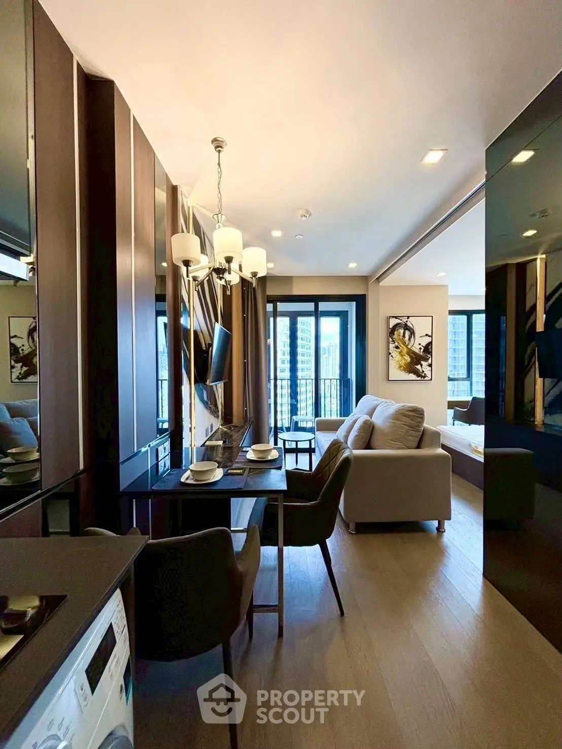 Modern open-plan living room with elegant decor and city view balcony.