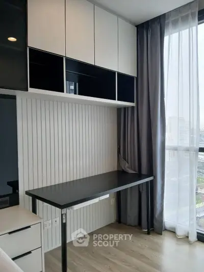 Modern study room with sleek desk and large window offering city views