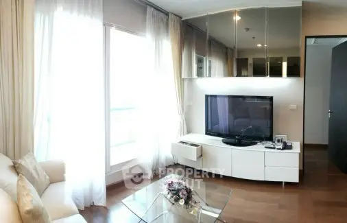 Modern living room with large TV and elegant decor