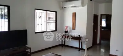 Spacious living room with modern air conditioning and natural light, perfect for relaxation.