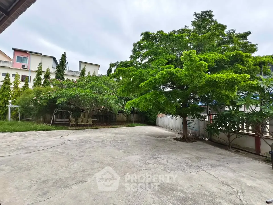 Spacious outdoor area with lush greenery and ample space for activities.