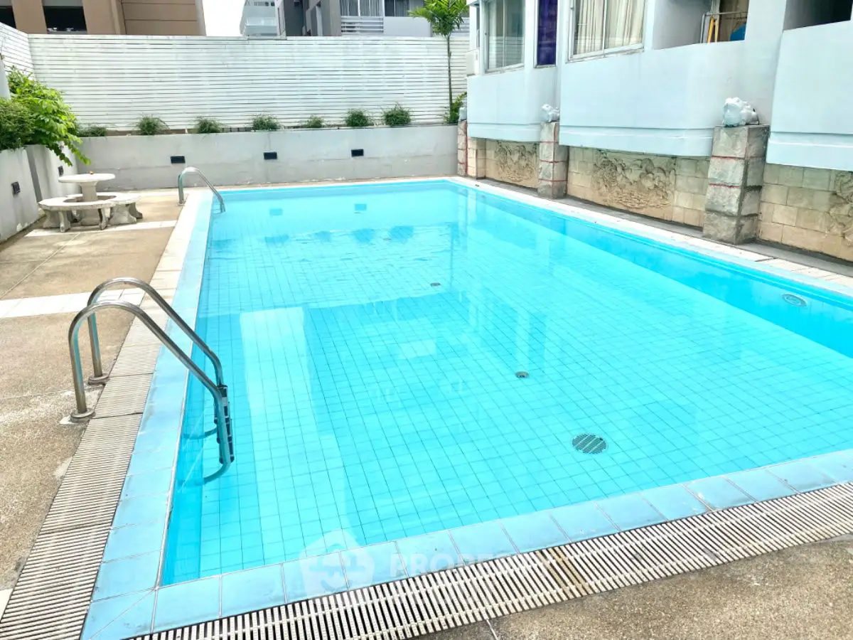 Inviting outdoor swimming pool with clean blue water and surrounding deck area.