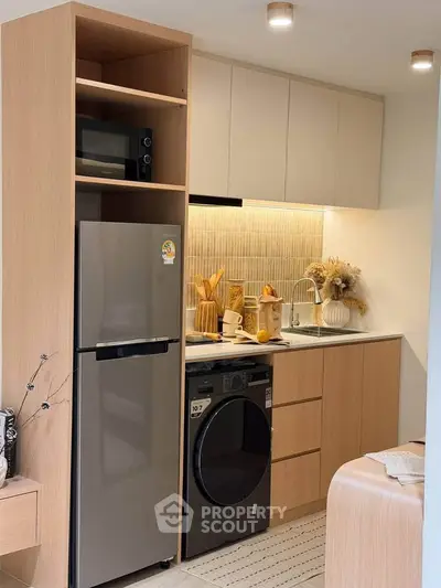 Modern compact kitchen with sleek appliances and stylish cabinetry