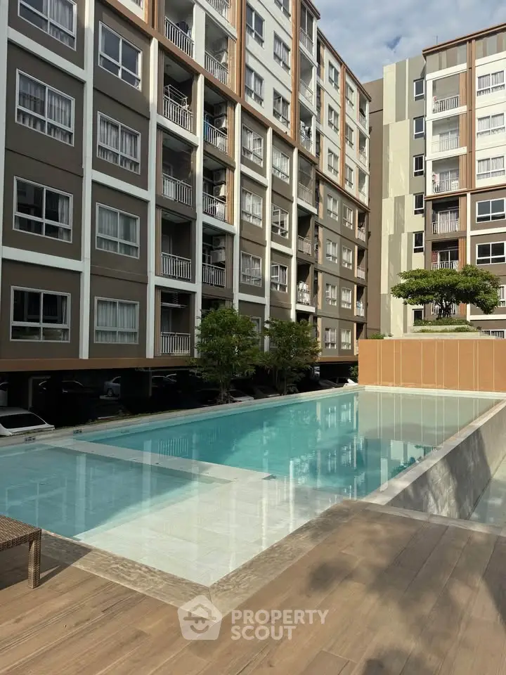 Modern apartment complex with a stunning outdoor pool and contemporary architecture.