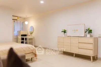Modern minimalist bedroom with light wood furniture and cozy decor
