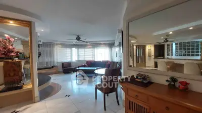 Spacious living room with elegant decor and large windows offering natural light