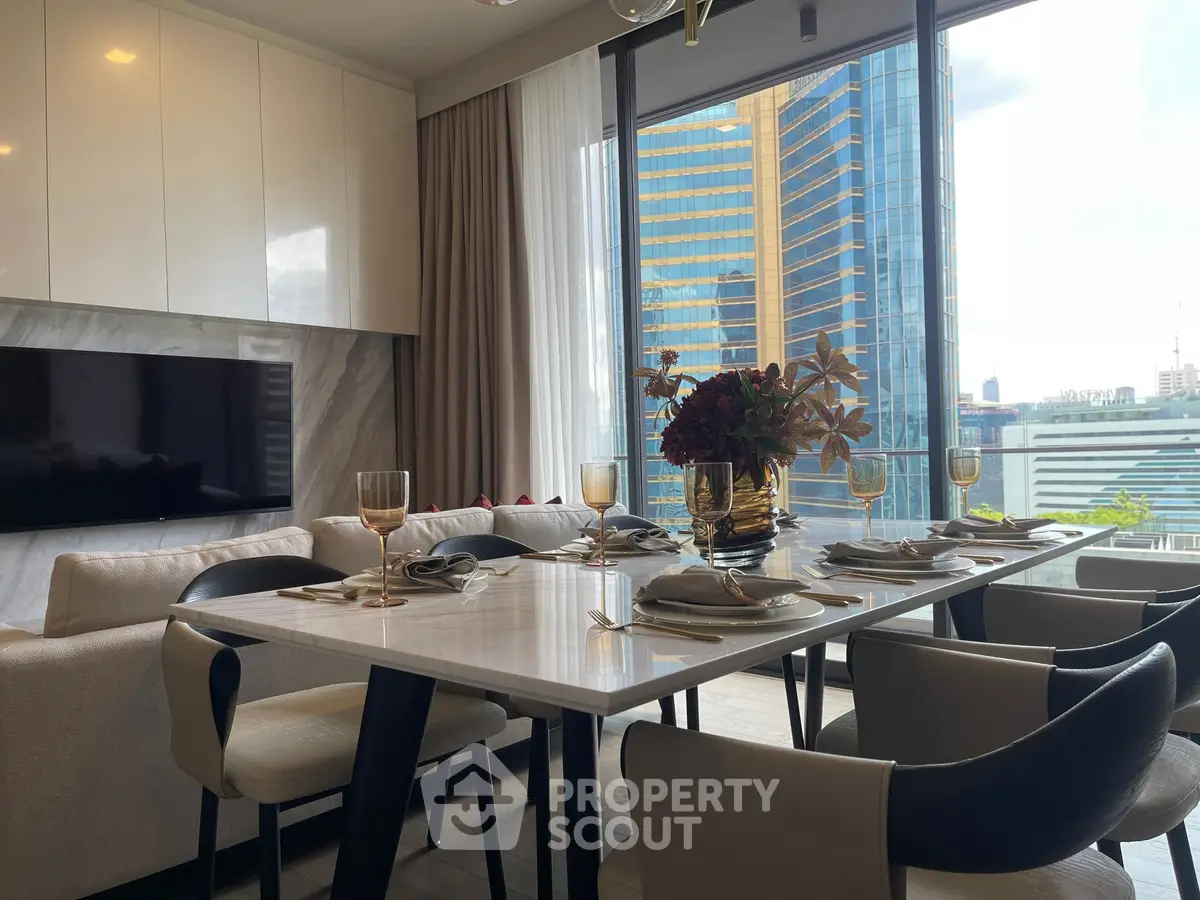 Luxurious dining area with elegant table setting and stunning city view through large windows.
