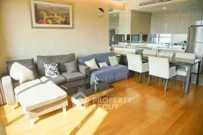 Spacious modern living room with elegant dining area and natural light
