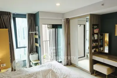 Modern bedroom with balcony access and stylish decor in urban apartment