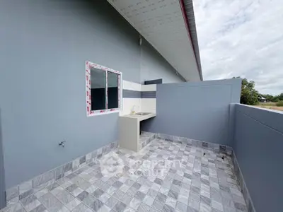 Modern outdoor patio with tiled flooring and built-in sink, perfect for entertaining.
