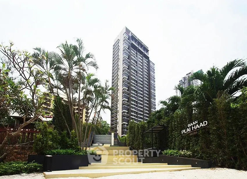 Luxurious high-rise building with lush greenery and modern entrance in prime location.