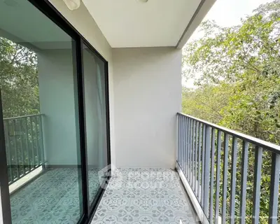 Charming balcony with elegant tile flooring and lush green views, perfect for relaxation and enjoying nature.