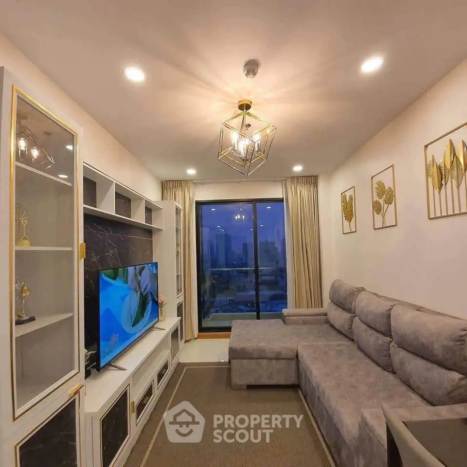 Luxurious living room with modern decor and stunning city view from large window.