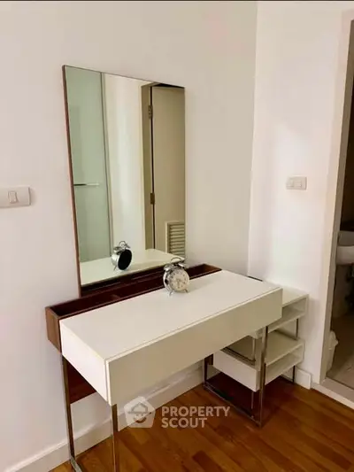 Stylish modern vanity table with mirror in a bright interior space.