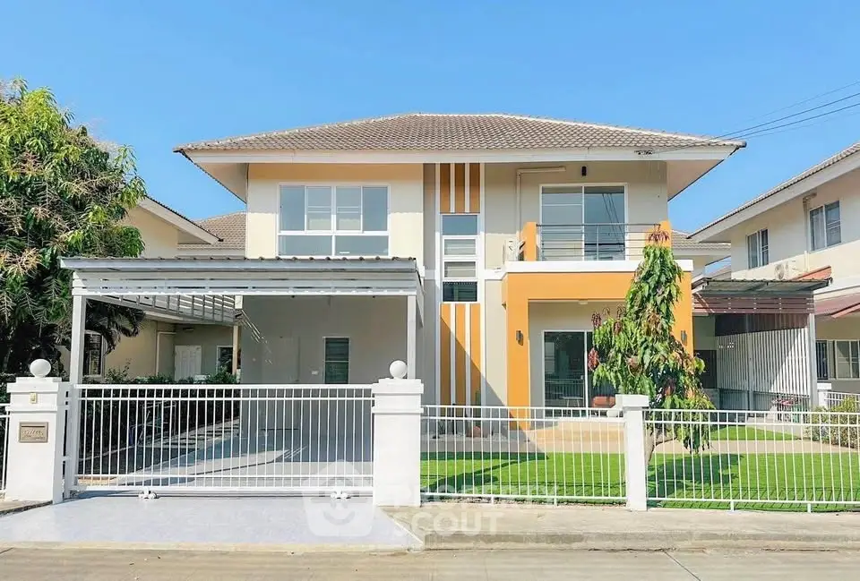 Modern two-story house with spacious driveway and manicured lawn in sunny neighborhood.