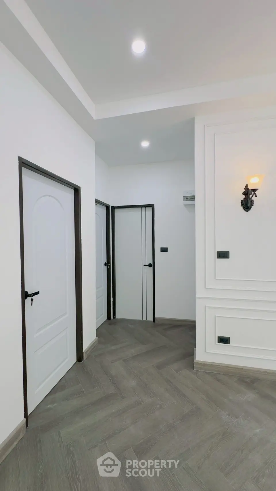 Modern hallway with elegant lighting and stylish flooring in a contemporary home.