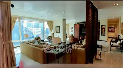 Luxurious living room with panoramic city views and elegant furnishings in a high-rise apartment.