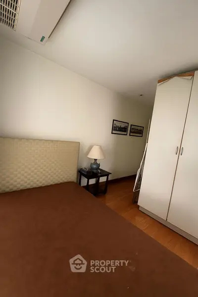 Cozy bedroom with modern decor and ample storage space