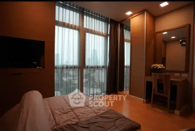 Luxurious bedroom with floor-to-ceiling windows and city view, featuring modern decor and cozy ambiance.