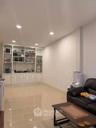 Spacious living room with elegant shelving and cozy seating area