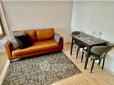 Modern living room with stylish sofa and dining area in cozy apartment.