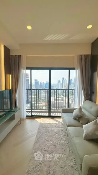 Modern living room with city view and elegant decor in high-rise apartment.