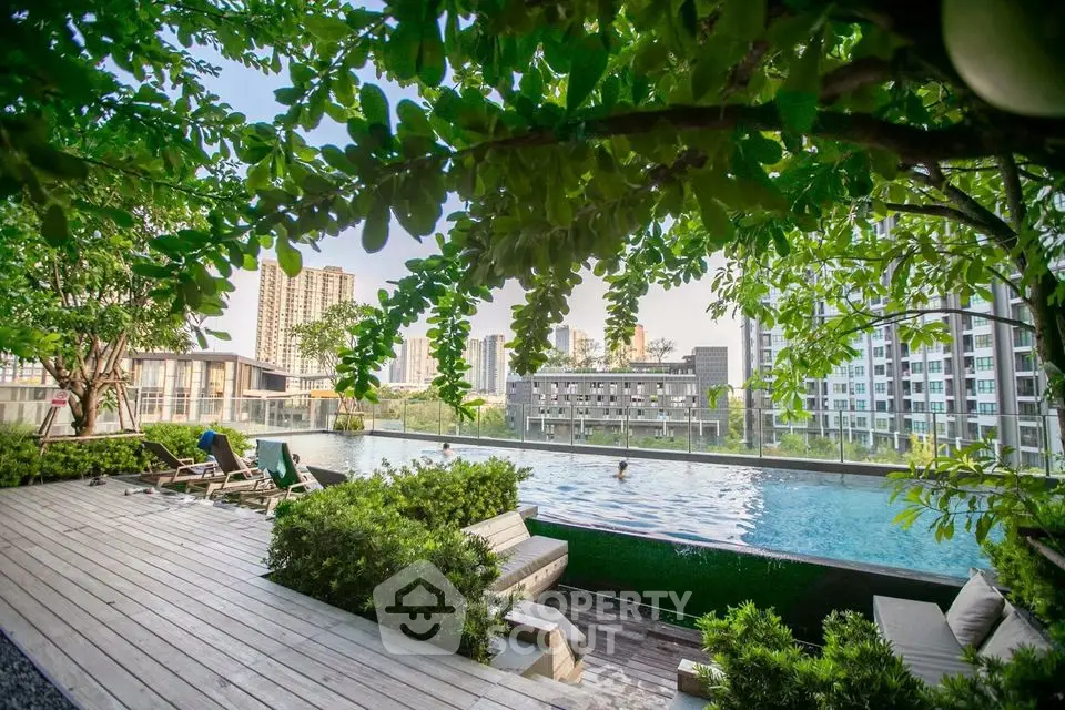 Luxurious rooftop pool with lush greenery and stunning city views