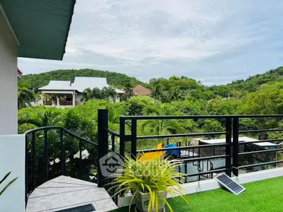 Stunning balcony view with lush greenery and modern railing, perfect for relaxation.