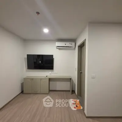 Modern minimalist room with air conditioning and wall-mounted TV, perfect for cozy living.
