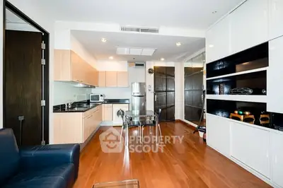 Modern open-layout kitchen with sleek cabinetry and hardwood floors