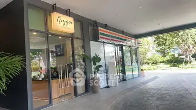 Modern commercial space with glass facade and lush greenery