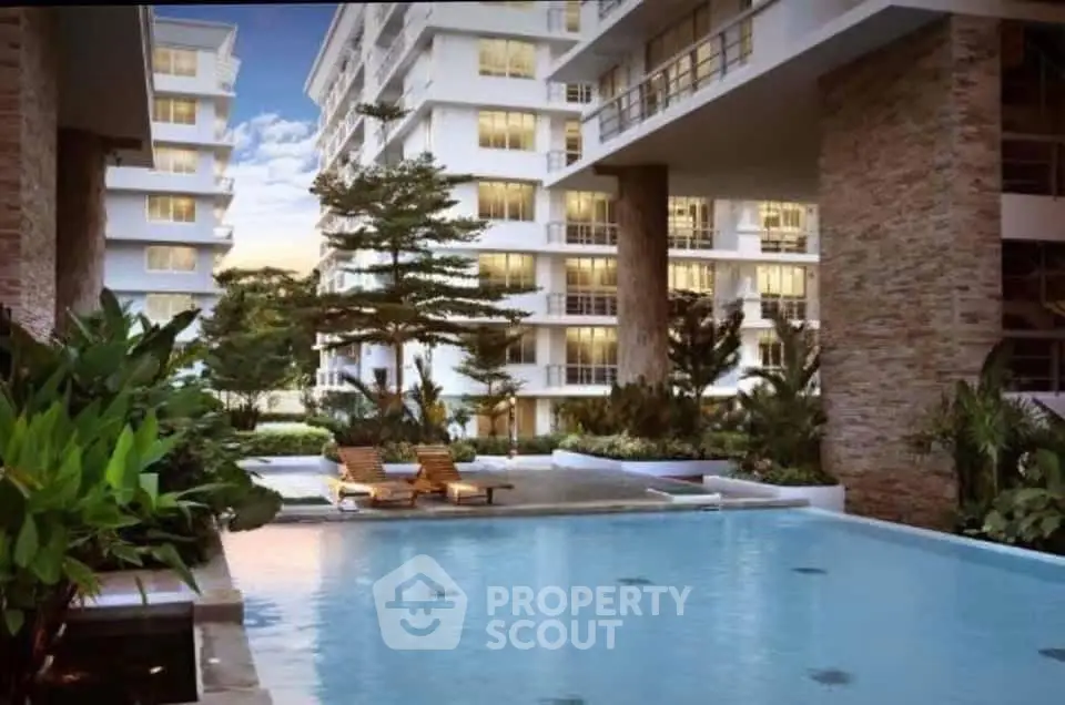 Luxurious residential complex with a stunning pool and lush greenery, perfect for modern living.